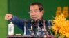 Cambodia's Prime Minister Hun Sen speaks to garment workers during a visit to a factory outside Phnom Penh, Cambodia, Wednesday, Aug. 30, 2017. Hun Sen is on a country-wide trip visiting the nation's factory workers to hear their hopes and concerns in person. (AP Photo/Heng Sinith)