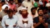 Supporters of Tahir ul-Qadri, Sufi cleric and leader of political party Pakistan Awami Tehreek, offer prayers in front of the Parliament House during the Revolution March in Islamabad, Aug. 22, 2014.