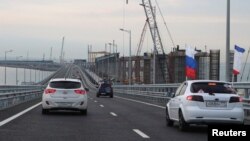 FILE - Cars drive along a bridge, which was constructed to connect the Russian mainland with the Crimean peninsula across the Kerch Strait, May 16, 2018. Russia annexed Crimea from Ukraine in 2014.