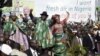 Nigeria’s President Goodluck Jonathan (C) leaves a rally with his wife Patience and Vice President Namadi Sambo (L) after declaring his bid for the 2011 presidential poll in Abuja, 18 Sep 2010