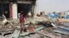 A man stands at the scene of an airstrike that hit a truck at a gas station in Abss, Yemen, April 24, 2018. 