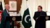 Pakistan's Prime Minister Nawaz Sharif (R) speaks during a joint news conference as Afghan President Hamid Karzai listens at the prime minister's residence in Islamabad, Aug. 26, 2013.