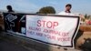 FILE - Journalists hold a banner while taking part in a demonstration in front of the Parliament building in Islamabad on January 28, 2013. 