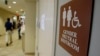 FILE - A sign marks the entrance to a gender-neutral restroom at the University of Vermont in Burlington, Vermont. The Obama administration has issued guidance for transgender students in the United States to be allowed to use the bathrooms that match their gender identity.