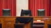 FILE - Supreme Court Justice Antonin Scalia’s courtroom chair is draped in black to mark his death as part of a tradition that dates to the 19th century at the Supreme Court in Washington, Feb. 16, 2016. 