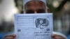 A Pakistani man holds a pamphlet, allegedly distributed by the Islamic State (IS), in the northwestern Pakistani city of Peshawar, Sept. 3, 2014 .