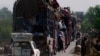 People fleeing the military offensive against the militants in North Waziristan, travel atop a vehicle with their belongings while entering Bannu, located in Pakistan's Khyber-Pakhtunkhwa province, June 20, 2014.
