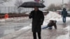 A man is seen slipping on ice during freezing rain on Roosevelt Island, in New York Jan. 5, 2014.