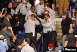 Police officers forcibly restrain a protester at U.S. Republican presidential candidate Donald Trump's campaign rally in Fayetteville, North Carolina, March 9, 2016.