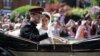 Prince Harry and his wife, Meghan Markle, wave as they ride a horse-drawn carriage after their wedding ceremony at St George's Chapel in Windsor, Britain, May 19, 2018. 