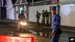 Maldives soldiers and policemen guard the main street after the government declared a 15-day state of emergency in Male, Maldives, Feb. 6, 2018. 