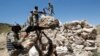 FILE - Afghan border policemen take their positions at the Goshta district of Nangarhar province border, where Afghanistan shares borders with Pakistan.