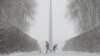 Workers remove snow during a heavy snowfall in Kyiv, Ukraine, Dec. 18, 2017. 