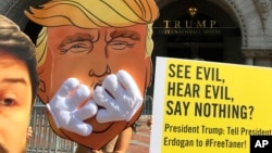 Members of Amnesty International demonstrate outside Trump International Hotel in Washington, June 15, 2017. They were urging the administration of President Donald Trump administration to end its silence on the imprisonment of Taner Kilic, the head of Amnesty International in Turkey. 