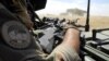 FILE - A soldier of France's Barkhane mission holds a weapon as he patrols in central Mali, in the border zone with Burkina Faso and Niger, Nov. 01, 2017. 