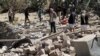 FILE - People walk on the rubble of a house destroyed by a Saudi-led airstrike in Sana'a, Yemen, Feb. 2, 2017. 