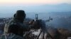 Syrian army personnel, backed by Russian airstrikes, fires machine gun in Latakia province, near border with Turkey, Oct. 10, 2015.