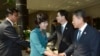 The head of North Korea's delegation Kim Song Hye, center, shakes hands with South Korean delegate Kwon Young-yang, right, upon their arrival for a meeting at the southern side of Panmunjom, in Paju, north of Seoul, South Korea, June 9, 2013. (Photo relea