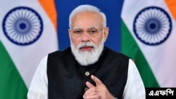 ইন্ডিয়ান প্রেস ইনফরমেশন ব্যুরো (পিআইবি) কর্তৃক প্রকাশিত এই ছবিটি ভারতের প্রধানমন্ত্রী নরেন্দ্র মোদী নতুন দিল্লিতে আফগানিস্তানের উপর একটি ভার্চুয়াল জি ২০ এক্সট্রাঅর্ডিনারি সামিটে অংশ নেওয়ার সময় কথা বলছেন।১২ অক্টোবর ২০২১। (ছবি-এএফপি/পিআইবি)