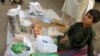 Adnan, 8, whose family fled from the military offensive against Pakistani militants in North Waziristan, sells ration packs collected by his family from a distribution point for internally displaced persons in Bannu, Pakistan, 