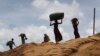 FILE - Rohingya girls carry firewood on their heads as they make their way through Kutupalong refugee camp, June 28, 2018, in Bangladesh.