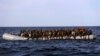 FILE - Migrants crowd a rubber boat as they are rescued by members of Proactive Open Arms NGO, in the Mediterranean Sea, about 22 miles north of Zumarah, Libya, Jan. 27, 2017.