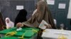 A woman casts her ballot at a polling station in Peshawar May 11, 2013.