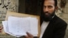 Mustafa Kharal, lawyer of pregnant woman Farzana Parveen who was stoned to death, shows her marriage certificate in Lahore, Pakistan, May 28, 2014. 