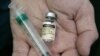 FILE - A doctor holds a vial of the human papillomavirus (HPV) vaccine Gardasil in his Chicago office. 