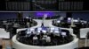 Traders work in front of the German share price index, DAX board, at the stock exchange in Frankfurt, Germany, May 18, 2017. 