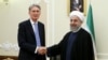 Iran's President Hassan Rouhani (R) welcomes British Foreign Secretary Philip Hammond at the start of their meeting in his office, in Tehran, Iran, Aug. 24, 2015.