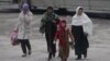 Women walk in Kabul, Afghanistan, on Wednesday, Jan. 4, 2012. The UN says the number of reported violent attacks against Afghan women has more than doubled in a year. 