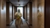 A staff worker disinfects a hotel floor inside the Olympic "closed-loop" during the Beijing 2022 Winter Olympics in Beijing, China, Feb. 8, 2022. 