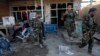 Afghan security forces assess damage after clashes between Taliban fighters and Afghan forces at Kandahar Airfield, Afghanistan, Dec. 9, 2015.