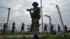 In this July 17, 2006 file photo, Border Security Force soldiers patrol the India-Pakistan border at Kanachak, about 15 kilometers (9 miles) west of Jammu, India. 