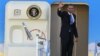President Barack Obama waves as he boards Air Force One before departing the Orlando International Airport for Washington to monitor Hurricane Sandy, in Orlando, Florida, October 29, 2012.