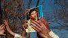 A supporter holds a picture of former Pakistani President Pervez Musharraf, during a protest with others at the Special Court where Musharraf will attend his trial in Islamabad, Feb. 18, 2014. 