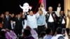 Ketiga pasangan Capres dan Cawapres berpegangan tangan dan berpose bersama usai debat terakhir di Jakarta Convention Center di Jakarta, Minggu malam 4 Februari 2024.