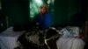 FILE - A teenage malaria patient sits in a bed at a hospital in Gao, northern Mali, Feb. 11, 2013.