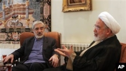 Leaders of Iranian opposition, Mahdi Karroubi, right, and Mir Hossein Mousavi talk in Tehran, 10 Oct 2009