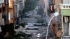 FILE - Damages are seen due to clashes between the Libyan military and Islamic militias in Benghazi, Libya. Representatives of Libya's rival factions who are sitting in Tunis and negotiating through a U.N.-brokered process announced on Tuesday that they have formed a unity government aimed at stemming the chaos that has engulfed the country for the past years.