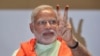 Gujarat state chief minister and the prime ministerial candidate of India's main opposition Bharatiya Janata Party (BJP), Narendra Modi, flashes a victory sign to the media during a meeting of the BJP members of Gujarat’s state legislature in Gandhinagar.