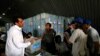 Afghan election workers count ballot papers during an audit of the presidential run-off in Kabul, Aug. 3, 2014.