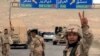 Forces loyal to Syria's President Bashar al-Assad gesture as they advance into the historic city of Palmyra in this picture provided by SANA, March 24, 2016.