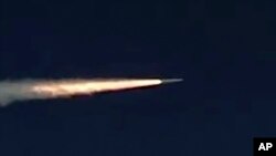 FILE - Russia's Kinzhal hypersonic missile flies during a test in southern Russia, in this photo made from the footage taken from Russian Defense Ministry official website on March 11, 2018. 