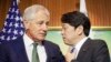 U.S. Defense Secretary Chuck Hagel, left, talks with Japanese Defense Minister Itsunori Onodera, right, as they wait for South Korean Defense Minister Kim Kwan-jin to arrive to begin their meeting, Saturday, May 31, 2014 in Singapore.
