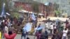 A still image taken from a video shot on October 1, 2017, shows protesters waving Ambazonian flags in front of road block in the English-speaking city of Bamenda, Cameroon. 