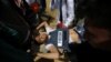 Palestinians evacuate a wounded journalist during clashes with Israeli troops at the Israel-Gaza border at a protest demanding the right to return to their homeland, in the southern Gaza Strip April 6, 2018. 