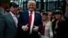 Republican presidential candidate Donald Trump poses for a picture with supporters at the end of a press conference with members of the New York Veteran Police Association in Staten Island, New York.