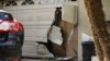 The garage door of Enrique Marquez's home is seen broken after a recent FBI raid, Dec. 9, 2015, in Riverside, California.